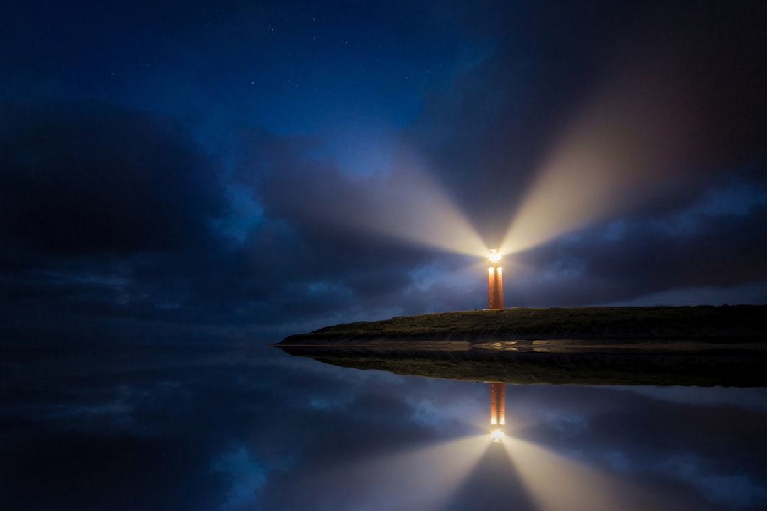 Lighthouse standing firm through a storm, symbolizing resilience