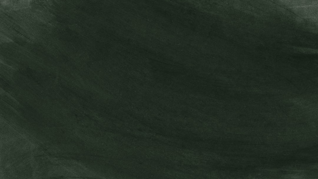 A worn, blank green chalkboard