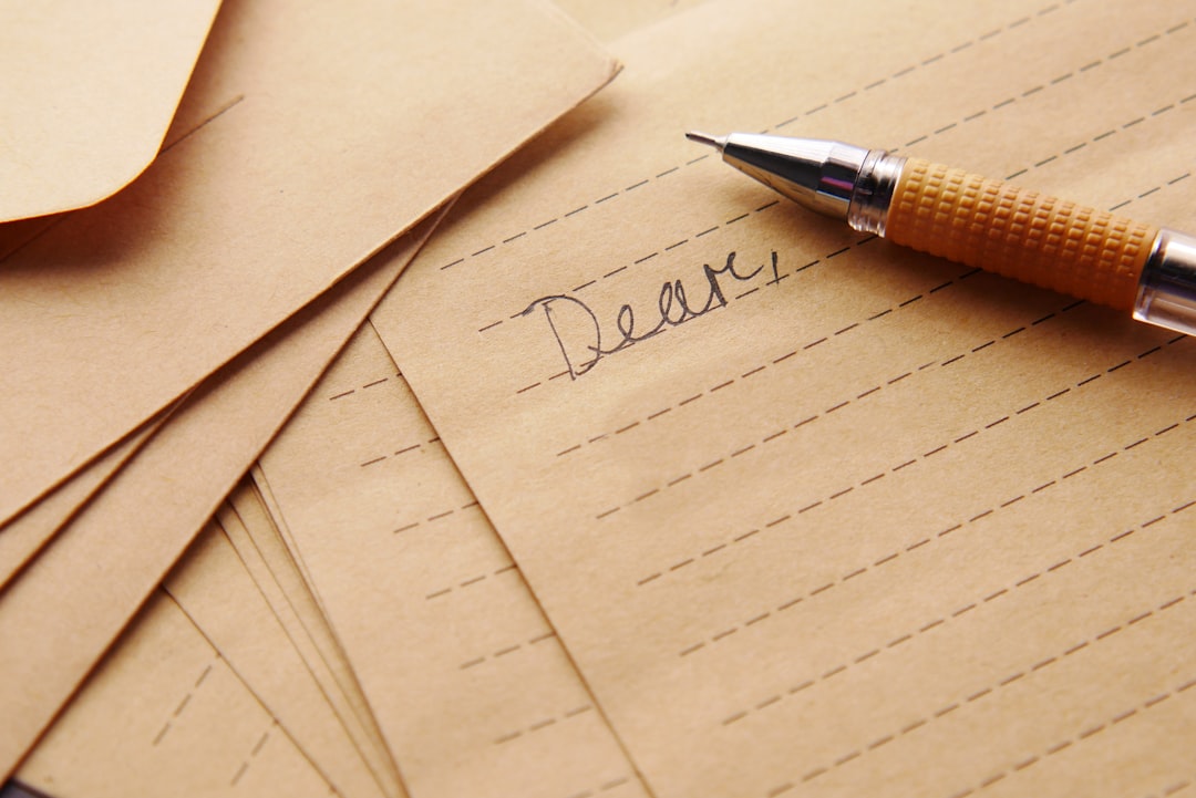 Envelope and pen on a writing desk