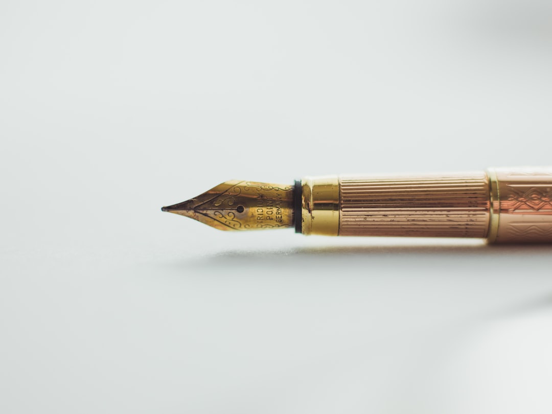 Fountain pen and ink on a dark writing desk