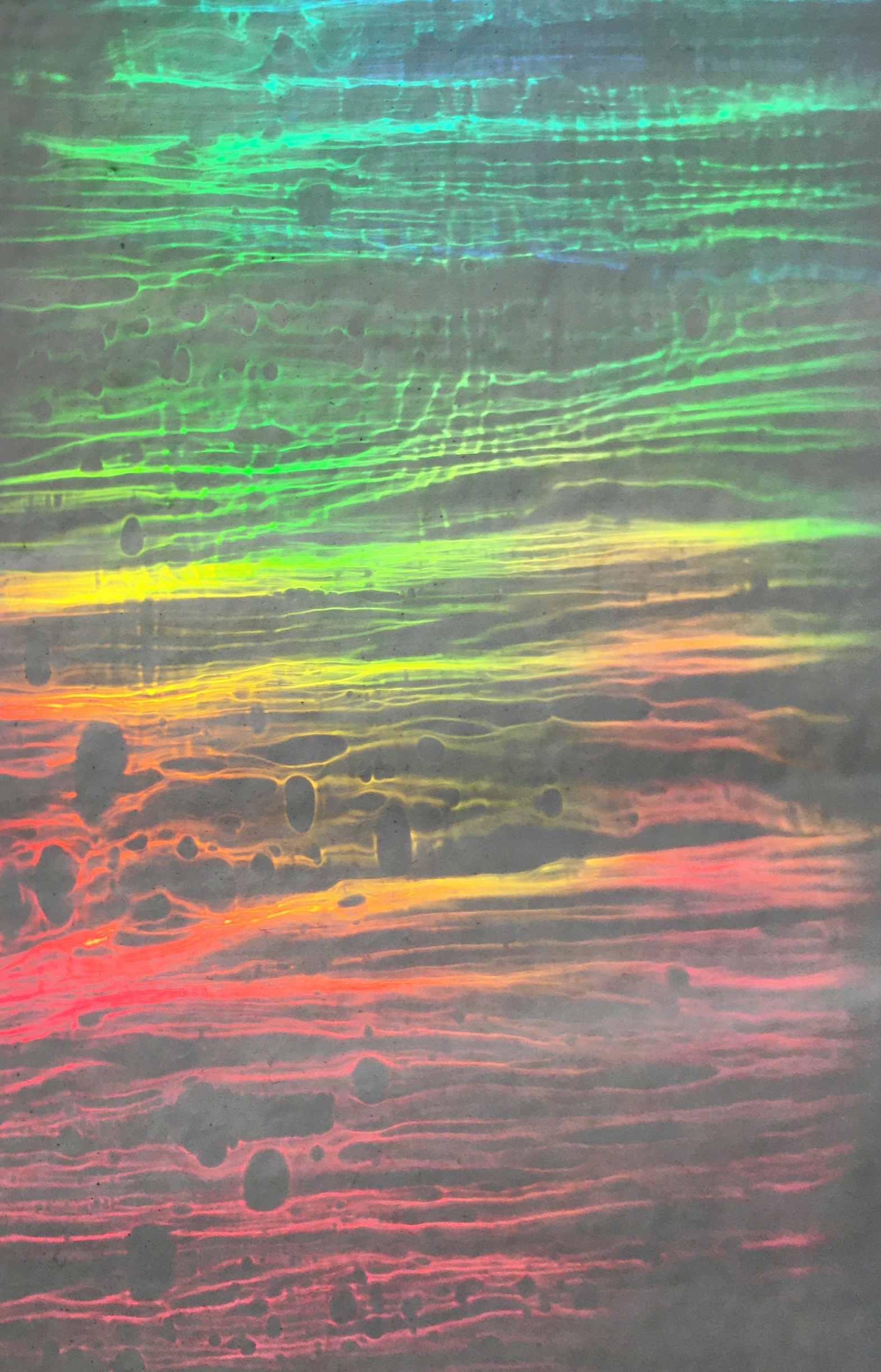 A spectrum of colored light bands refracted through handmade glass