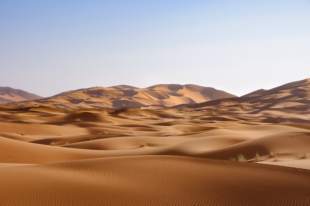 Golden desert dunes at sunset, evoking the ancient Mesopotamian setting of the Epic of Gilgamesh